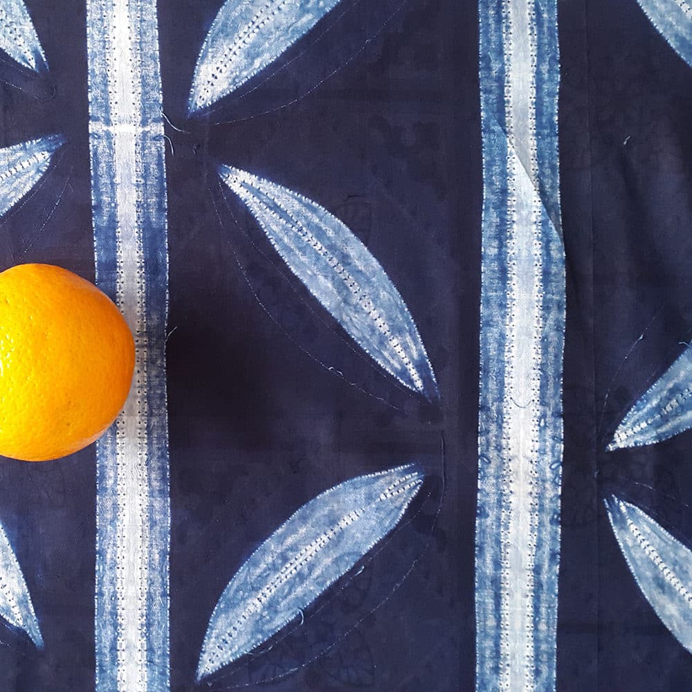 close-up detail of machine stitched indigo fabric from Nigeria